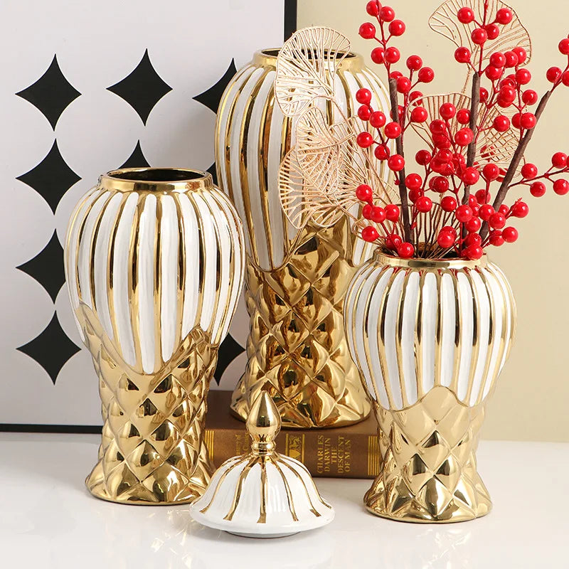 Three handcrafted ceramic decorative vases in gold and white with textured patterns.