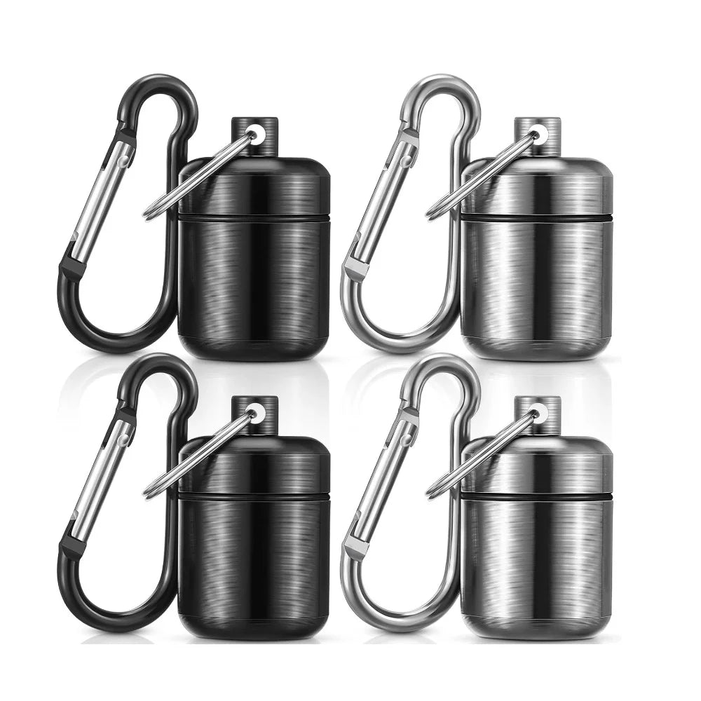 A set of stainless steel mini waterproof pill organizers with attached keyrings shown in various finishes.