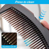 Close-up of a dark gray scalp massage comb with silicone bristles being squeezed to remove dirt.