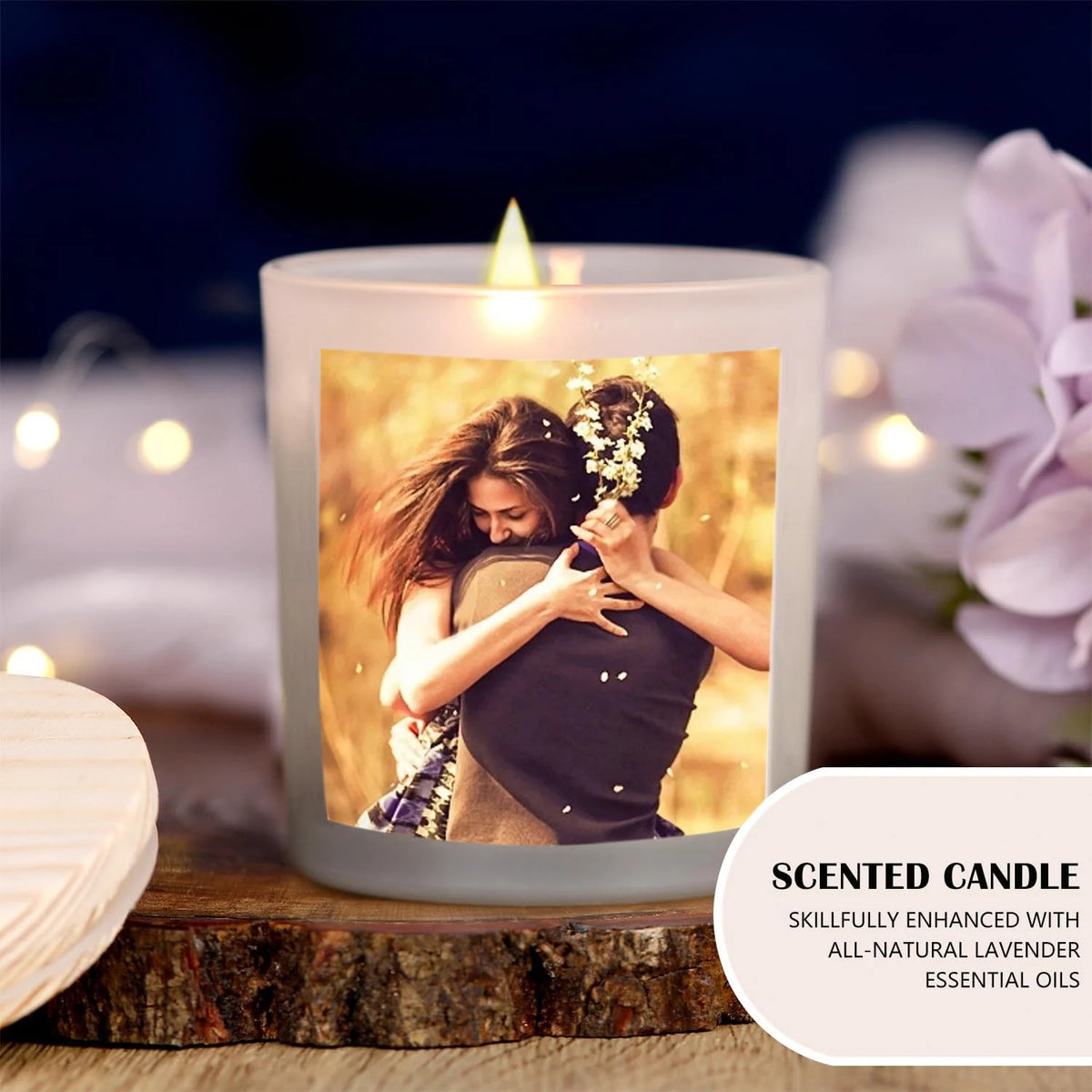 A glowing soy candle in a glass holder features a photo of a couple, set on a wooden surface.