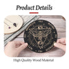 A black wooden divination board with symbols and text is shown next to a light wood coaster.