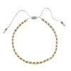 Handmade boho glass bead bracelet with an adjustable cord featuring small gold and gray beads.