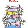 A stack of colorful books with pink, yellow, and blue spines, decorated with green foliage and bows.