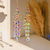 A pair of gold crystal suncatcher wind chime ornaments featuring purple and blue faceted crystals.