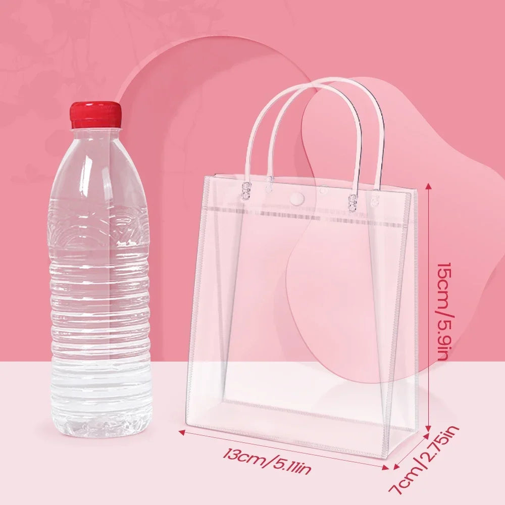 Clear reusable PVC gift bags with handles displayed on a pink background.
