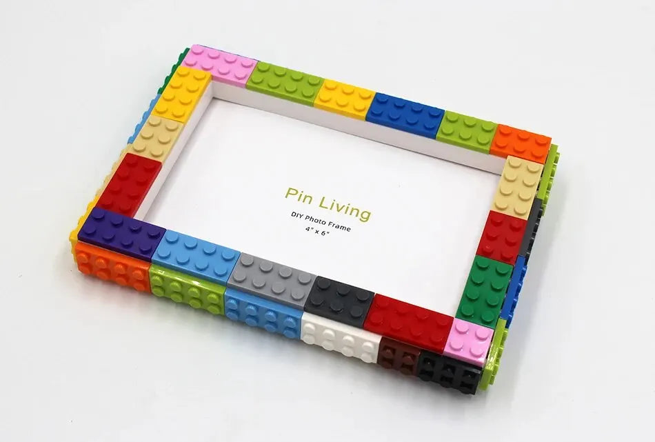A colorful building block photo frame kit with a white border and various colored blocks surrounding the frame.
