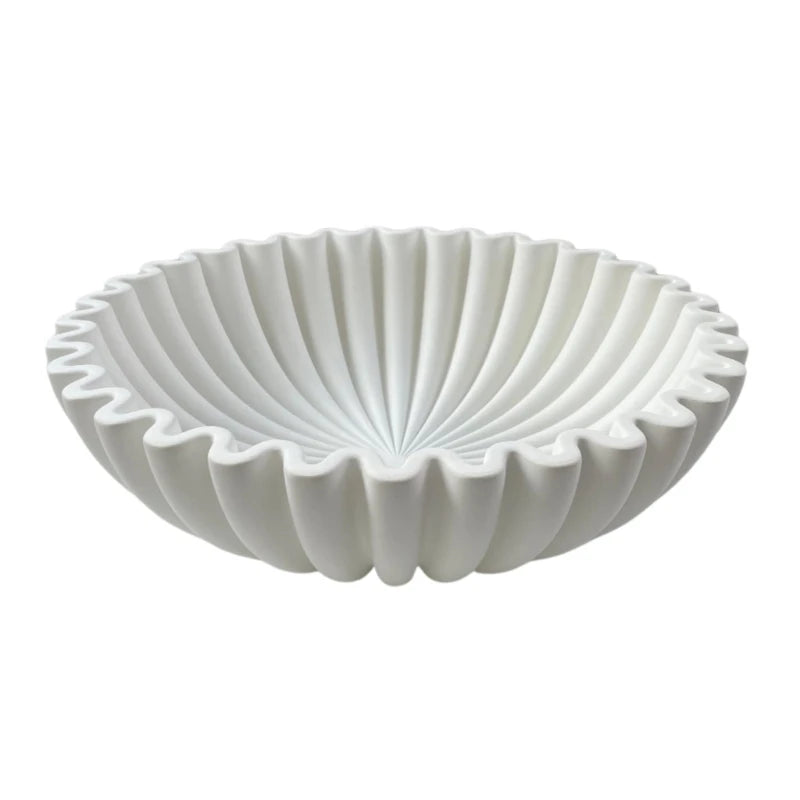 A white modern ruffle scalloped decorative bowl with deeply fluted sides.