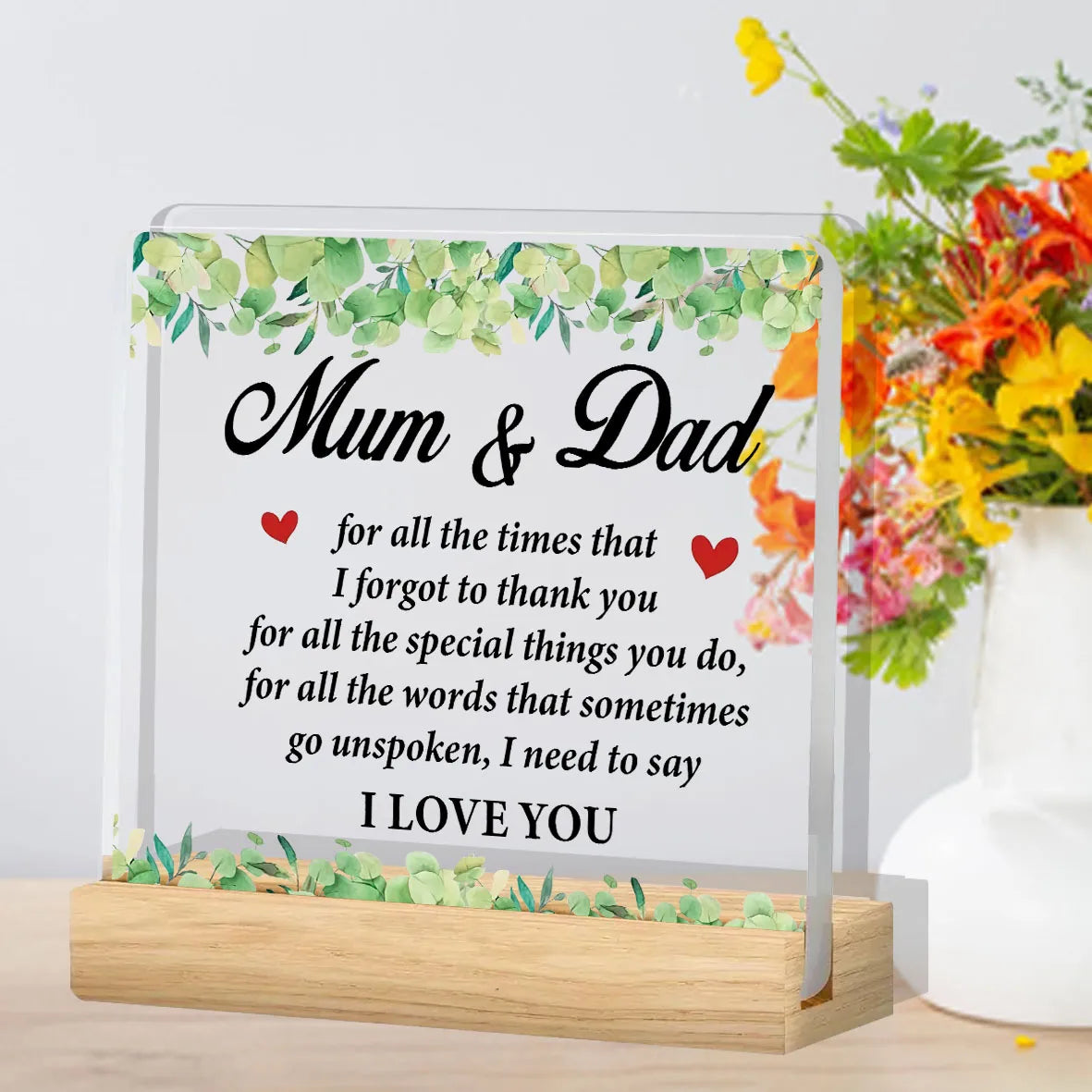 A clear acrylic plaque with a floral border and text that reads Mum & Dad for all the times I forgot to thank you and I love 
