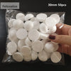A hand holds a clear plastic bag filled with 50 white polystyrene foam balls for crafting.