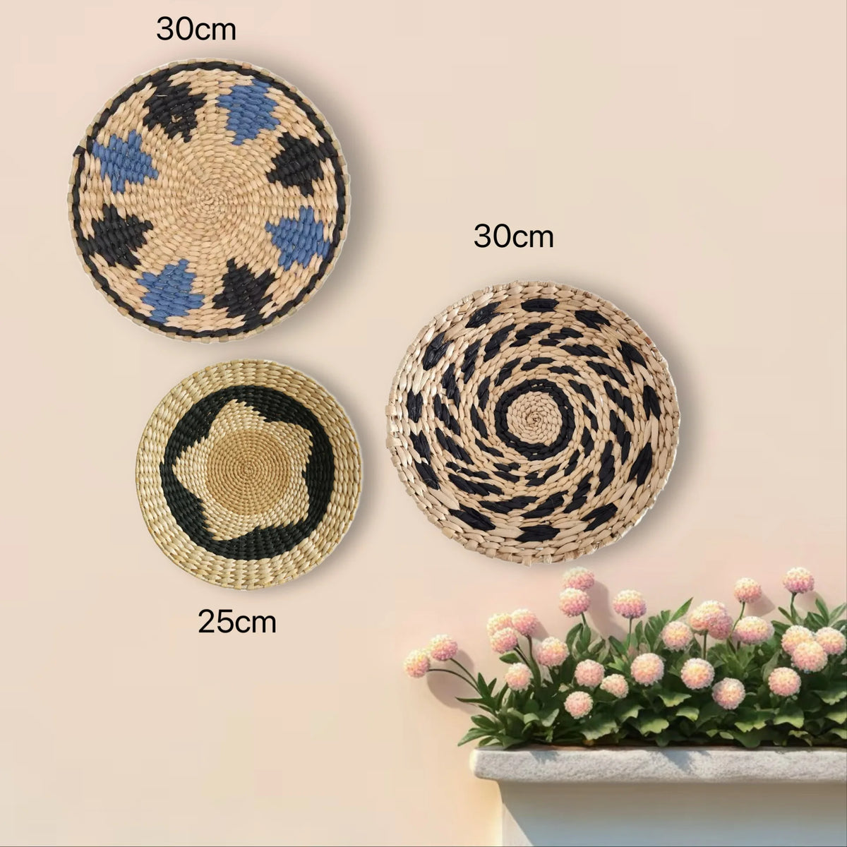 Three round boho straw wall hangings in black and blue patterns displayed on a light background.