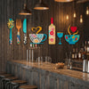 A set of rustic wood floral kitchen decor featuring wooden utensils and colorful ceramicware hanging on a dark wooden wall.