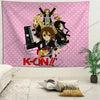A pink wall tapestry featuring an anime style illustration of a maid character with a guitar and the text K-ON!