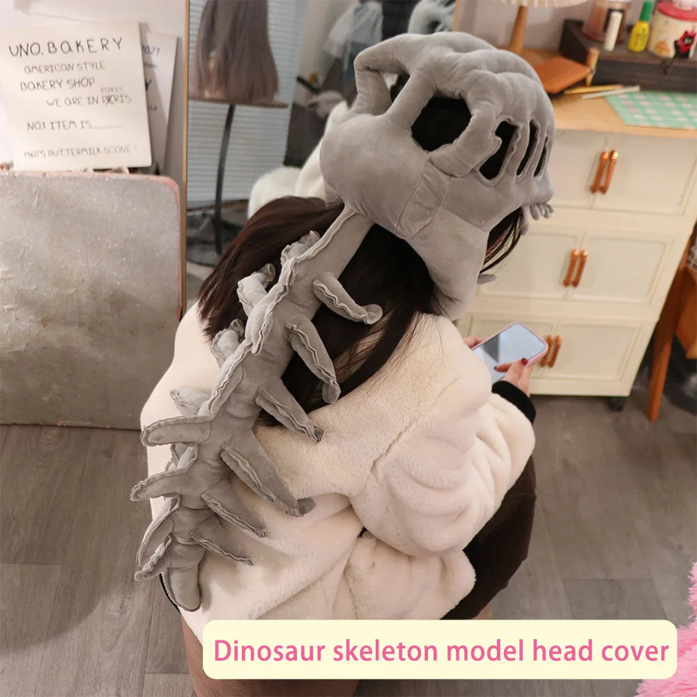 A realistic grey dinosaur skeleton model head cover worn by a person, displayed in a soft white fluffy jacket.