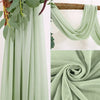 Light sage green sheer chiffon curtains draped and folded for events