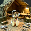A female rifleman desktop figurine wearing tactical gear is displayed in a desert-like setting.