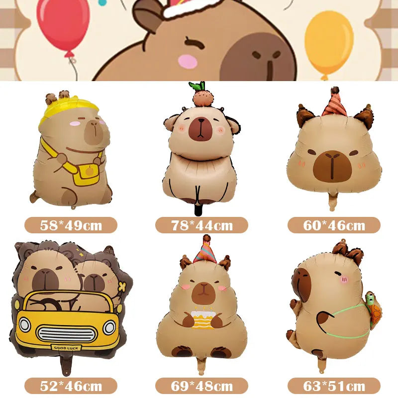 A set of plush capybara-themed birthday party decorations including a bear, a small animal, and a yellow car.