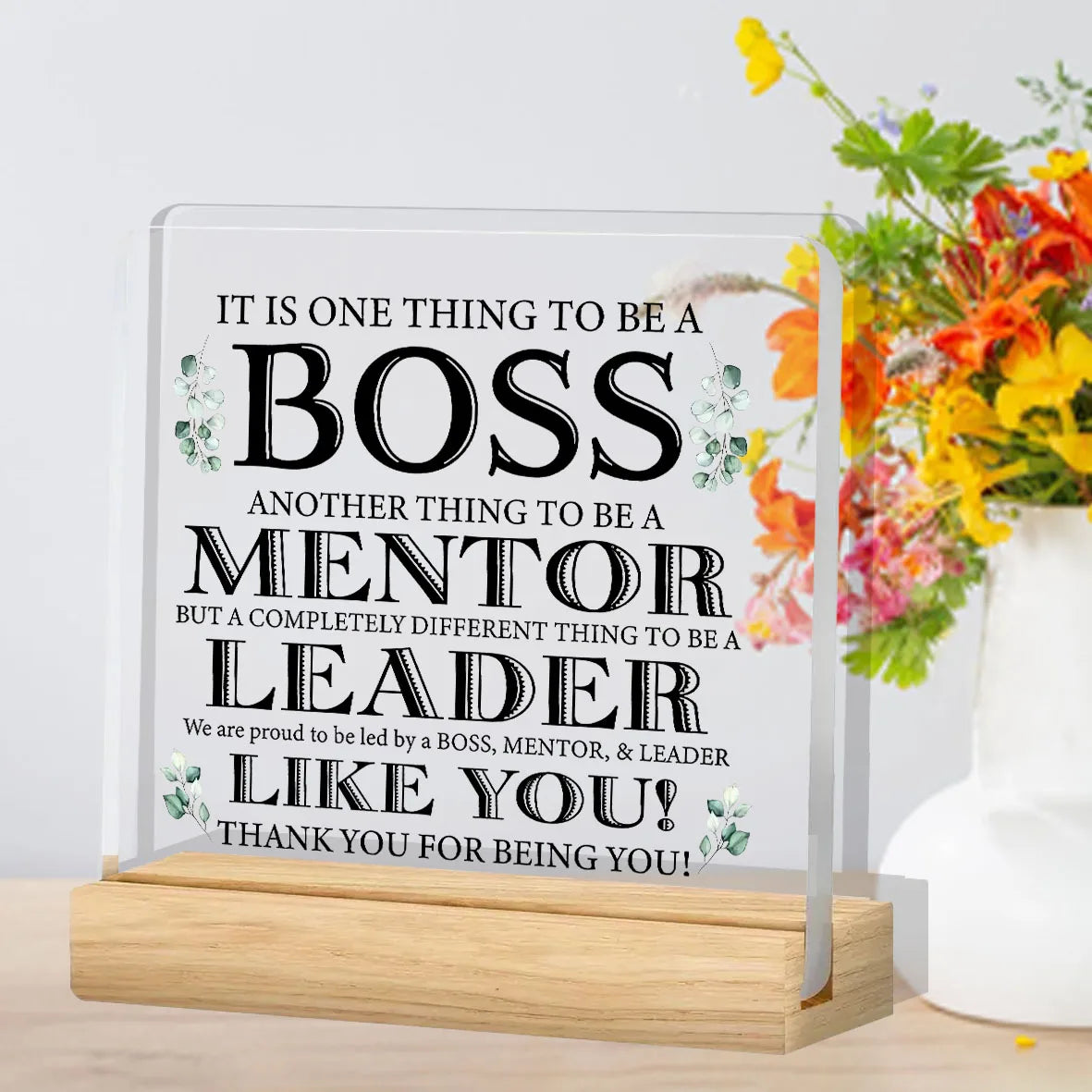 A clear acrylic plaque with engraved text appreciating a boss, mentor, and leader.