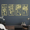 A set of four gold-toned metal wall decor panels featuring abstract female line art silhouettes on a dark gray wall.