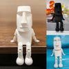 A white 3D printed Moai statue figurine with movable joints shown in a studio setting.