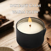 A dark candle in a ceramic holder with a lit wick, creating a warm glow for instant calm.