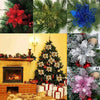 A collection of silk artificial Christmas flowers with gold sparkle finish, including red, blue, and pink blooms.