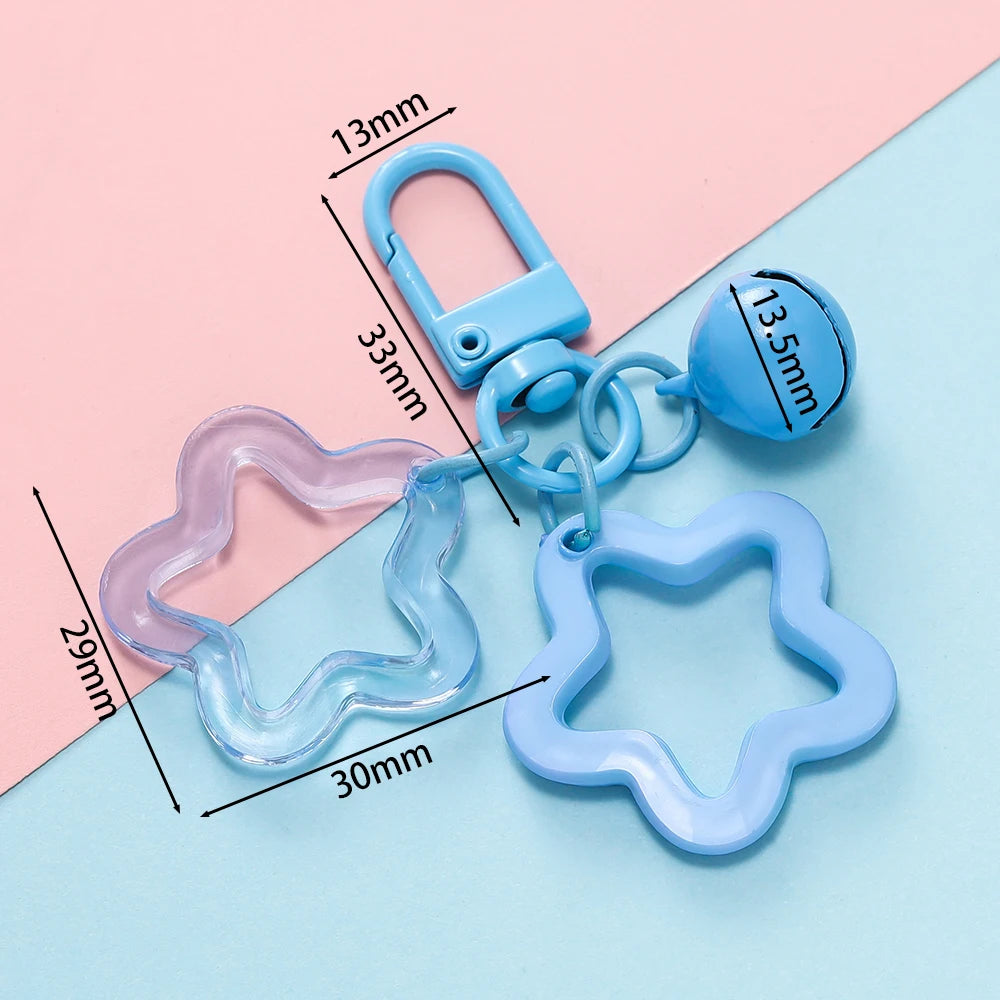 A collection of light blue and pink plastic charm pendants and keychains with various shapes and sizes.