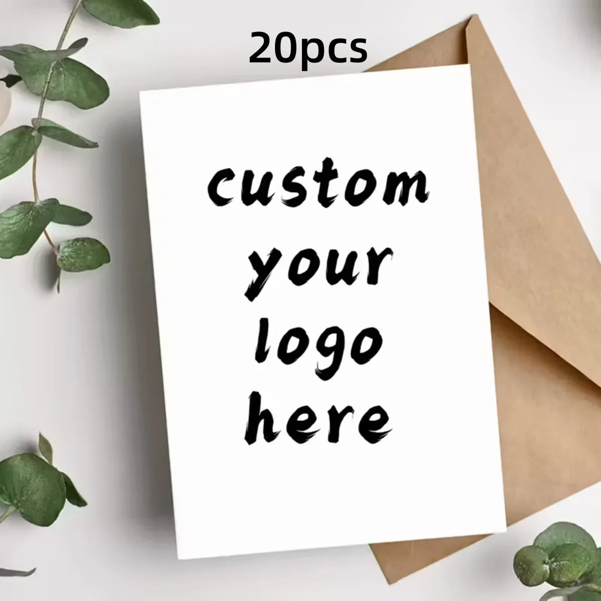 A white greeting card with black text that says custom your logo here is shown next to a kraft paper envelope.