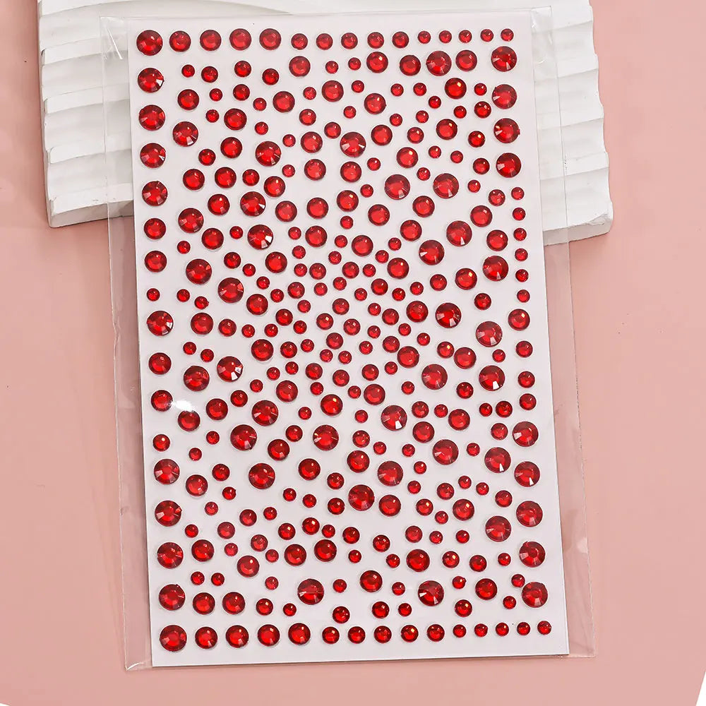 A sheet of red and clear glitter gems for stick-on facial tattoos.