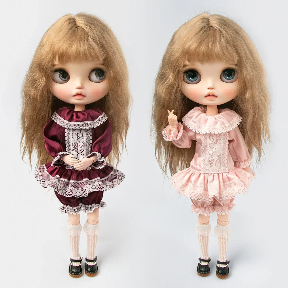A pair of vintage lace pajama sets for 1/6 dolls, featuring a maroon and pink ruffled outfit with blonde hair.