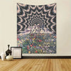 Wall tapestry featuring a psychedelic eye design radiating from a mountain peak over a field of colorful flowers.