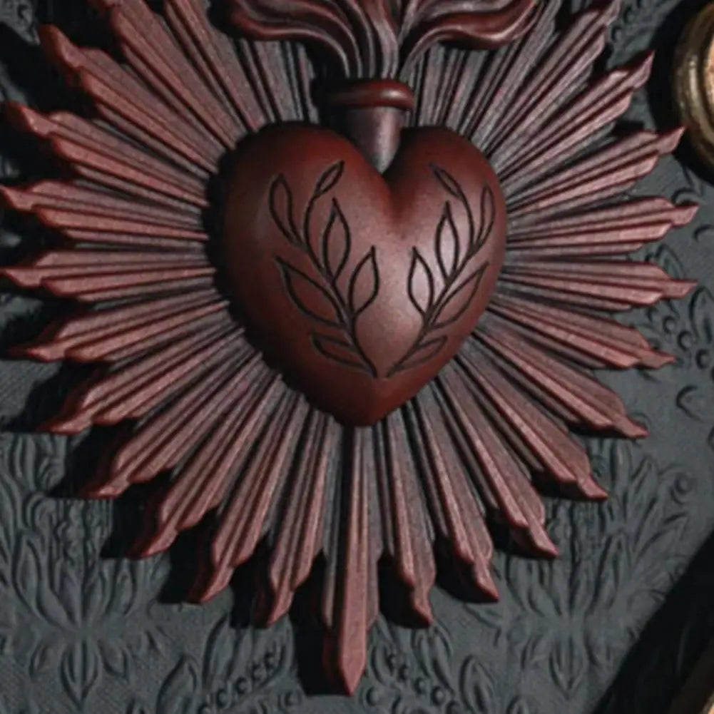 A dark brown Gothic sacred heart wall plaque featuring a heart surrounded by radiating rays.