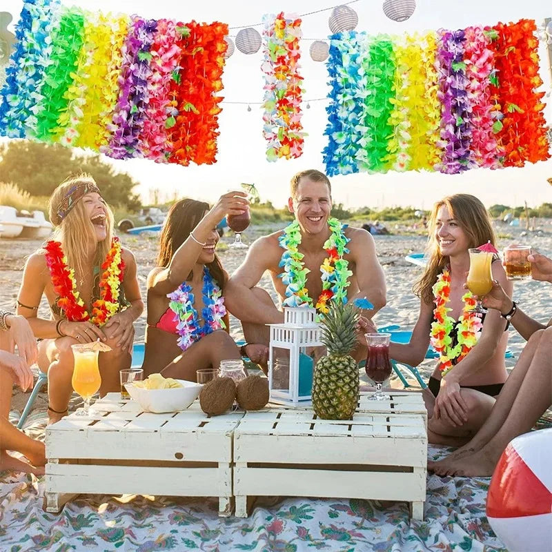 A group of people celebrating outdoors with colorful tropical flower leis and drinks.