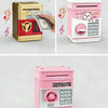 A pink and gold ATM-style piggy bank with an electronic lock and a separate pink cash box.