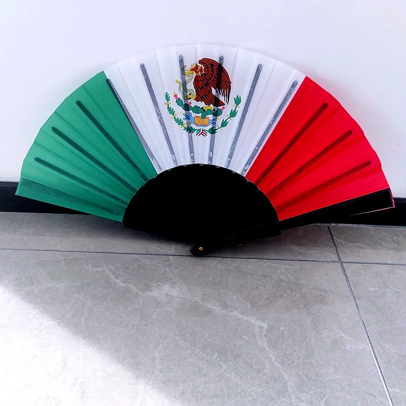A handheld folding fan featuring the flag of Mexico with red, white, and green colored ribs.