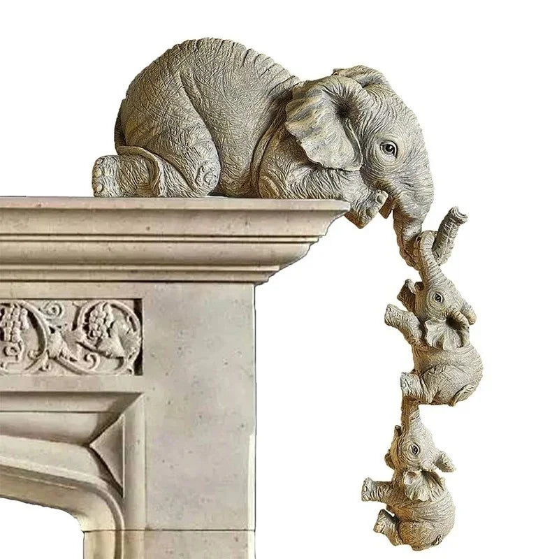 A resin figurine set showing an adult elephant gently hugging a baby elephant, displayed on a stone pedestal.