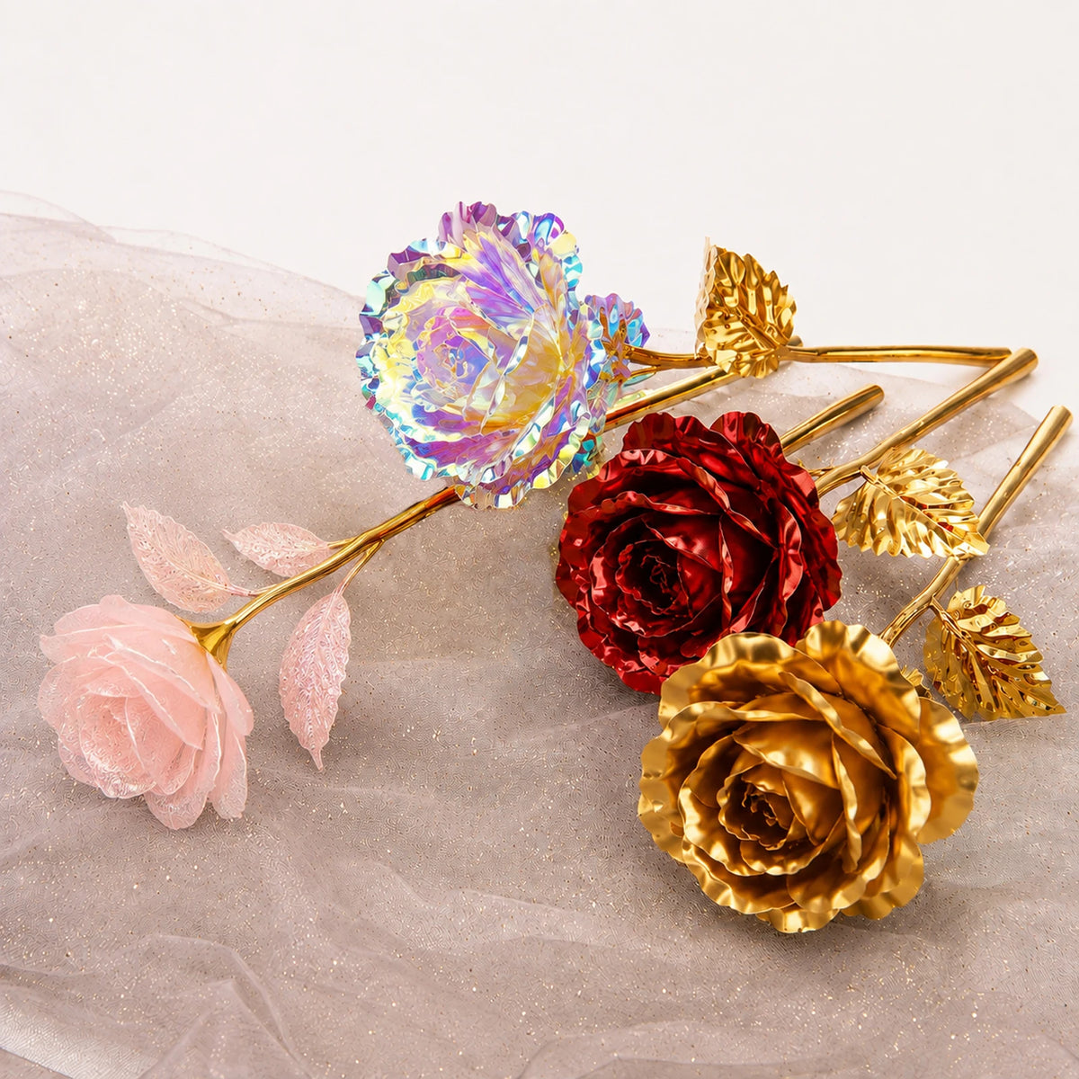 A collection of artificial roses in iridescent and gold foil finishes displayed on a textured surface.