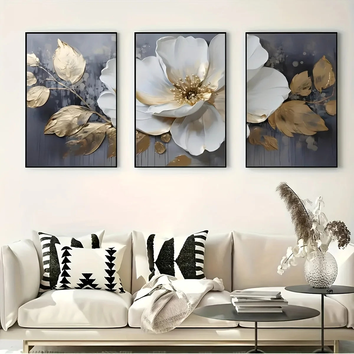 A set of three modern abstract floral wall art prints featuring white and gold leaves on a dark background.