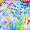 A colorful assortment of clear mini bubble bottles and plastic straws scattered on a bright background.
