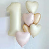 A cluster of light pink and cream heart-shaped foil balloons floating against a white background.
