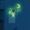Wall stickers featuring an astronaut, stars, and a crescent moon on a dark blue background.