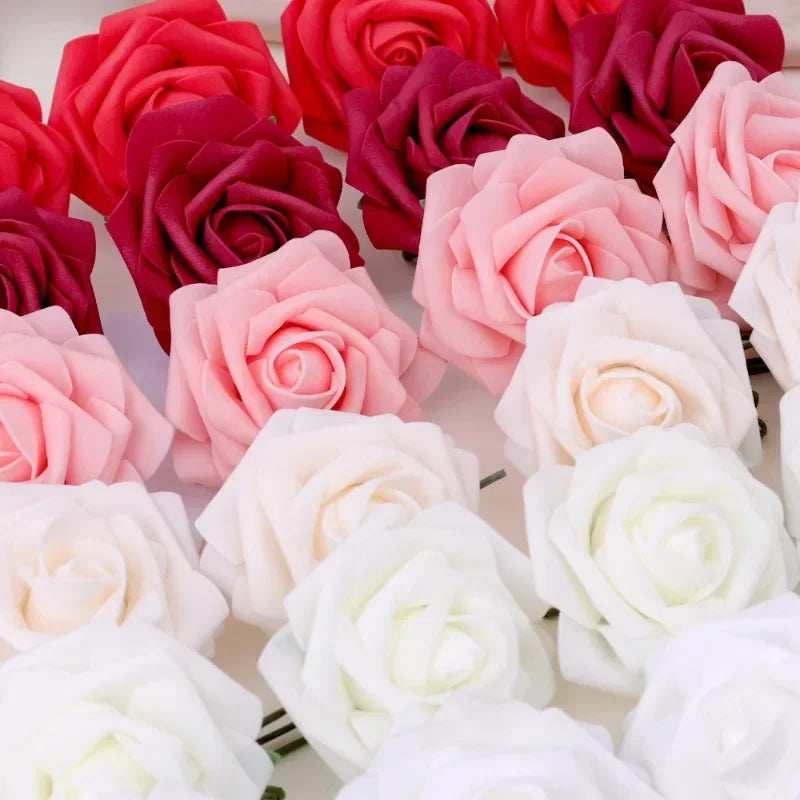 A close-up display of realistic foam rose flower heads in shades of pink, red, and white.