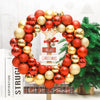 A wreath made of shiny red and gold Christmas ball ornaments decorated with a star and green pine branches.