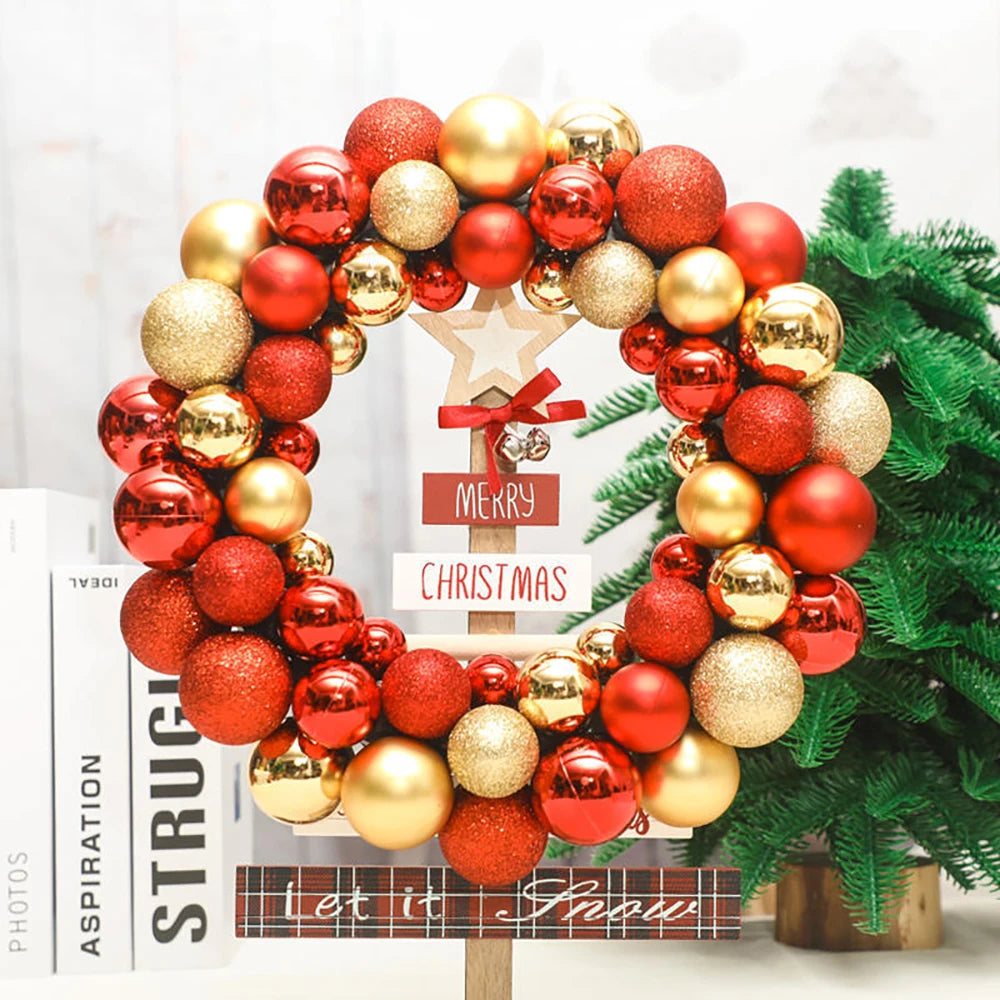 A wreath made of shiny red and gold Christmas ball ornaments decorated with a star and green pine branches.