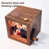 A wooden hand-crank flip photo frame with a glowing light, featuring a photo inside.