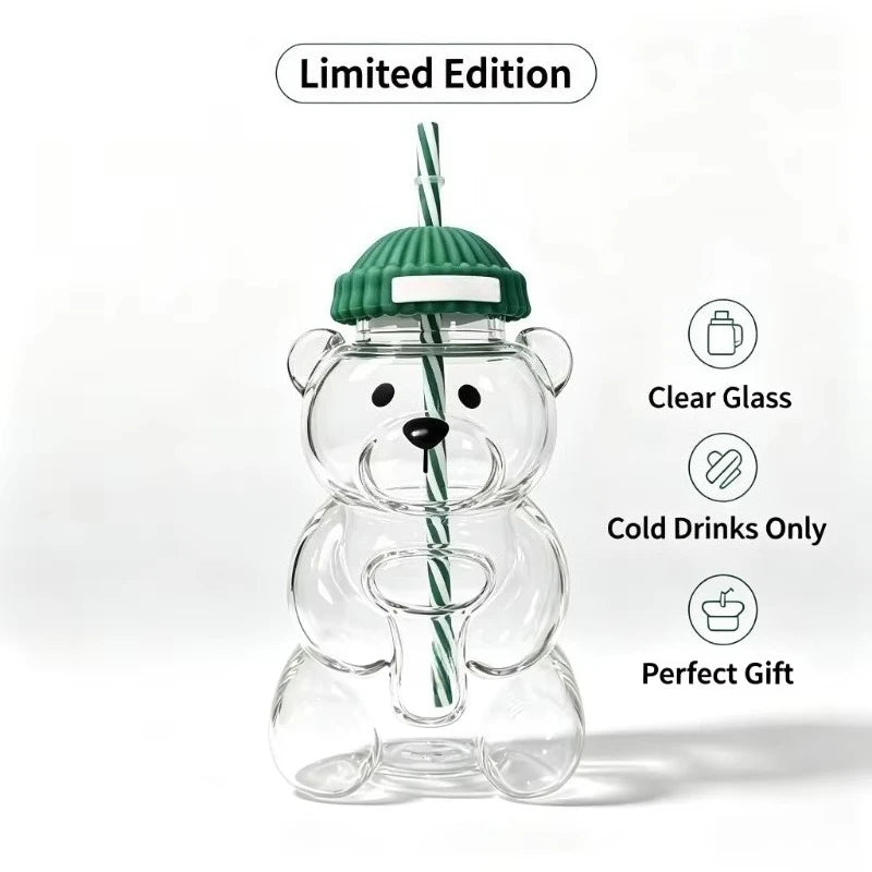 A clear glass bear-shaped coffee cup with a green lid, presented as a limited edition gift.