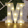 A large, illuminated letter M made of white acrylic with warm white LED lights.