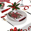A festive poinsettia and holly Christmas tablecloth displayed on a plate with silverware and holiday greenery.