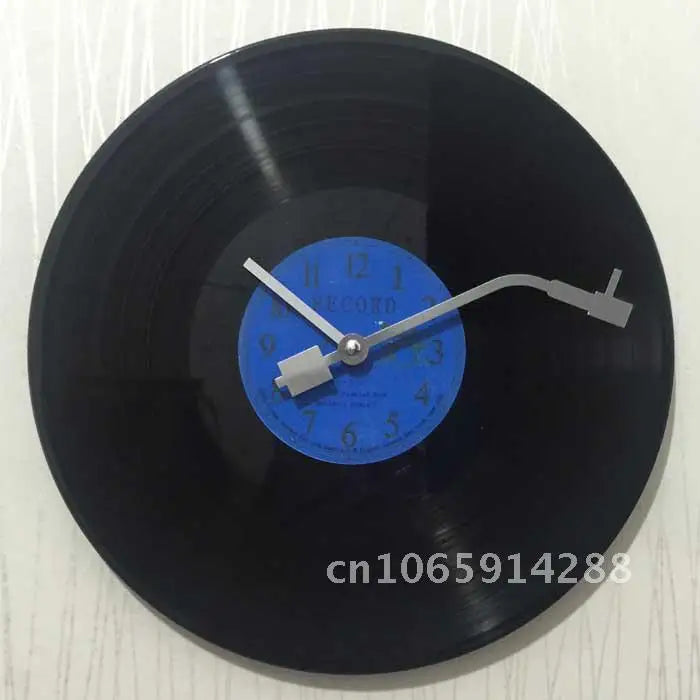 A close-up view of a black vinyl record with a blue clock face and hands.