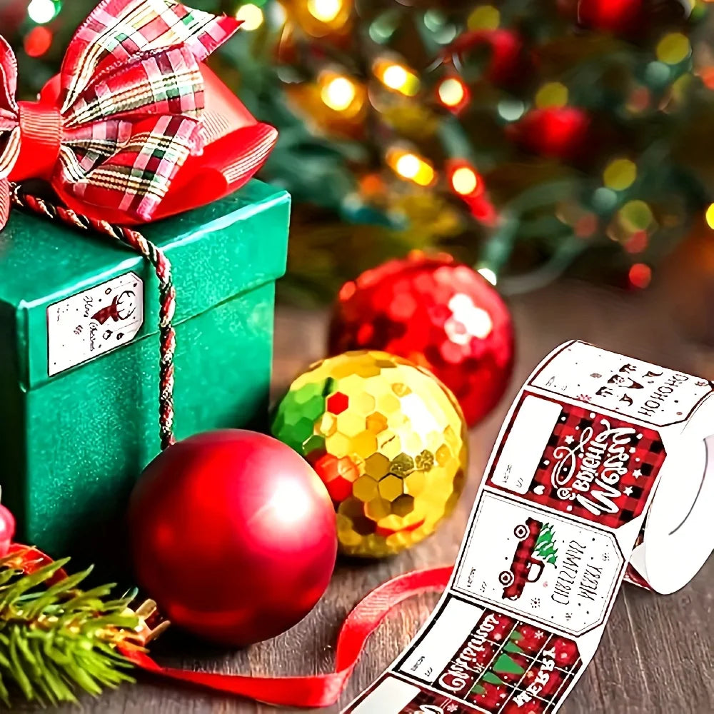 A roll of Christmas present stickers with festive designs and a red ribbon, set against a blurred background of holiday light