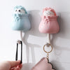 Pink and blue cartoon cat wall hooks with hanging loops for organization